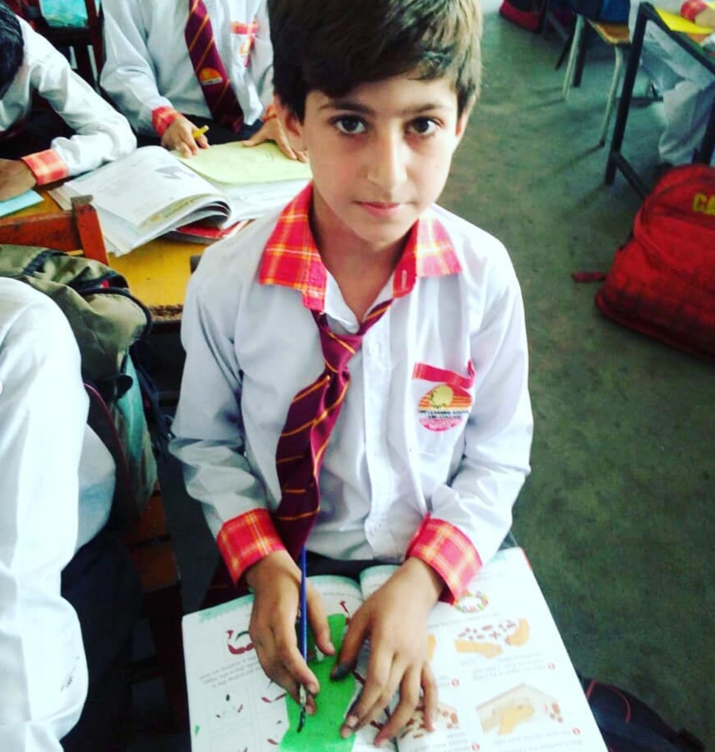 Pakistani student in classroom — community empowerment through education